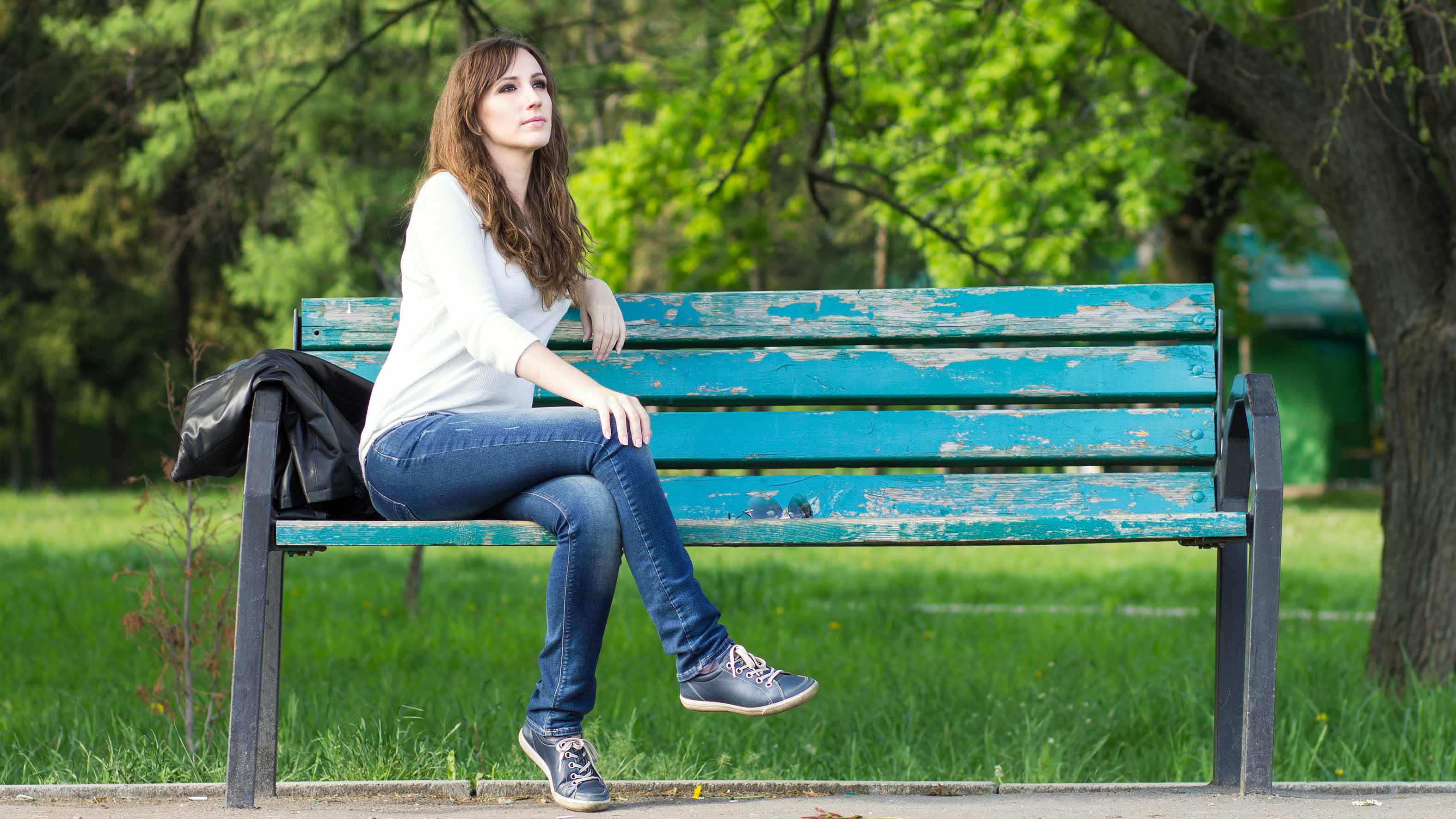 Preggy female sitting upskirt on the city park bench